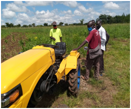 Three Ugandan youth being trained on tractor use. Talanta is partnering with Mzanzi, a South African based agri-machineries manufacturer, to bring loan this tractor to youth.
